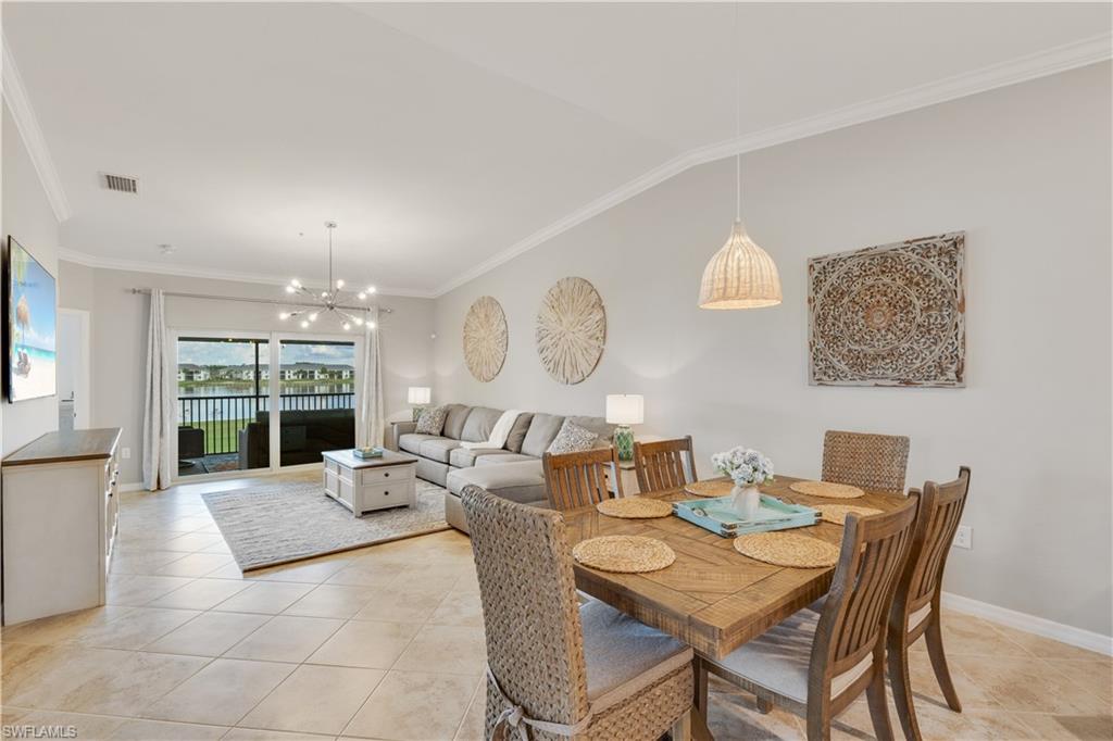 43041 Greenway Boulevard, Unit 921 Babcock Ranch, FL 33982 - Photo 5 of 15 a living room with fireplace furniture and a large window