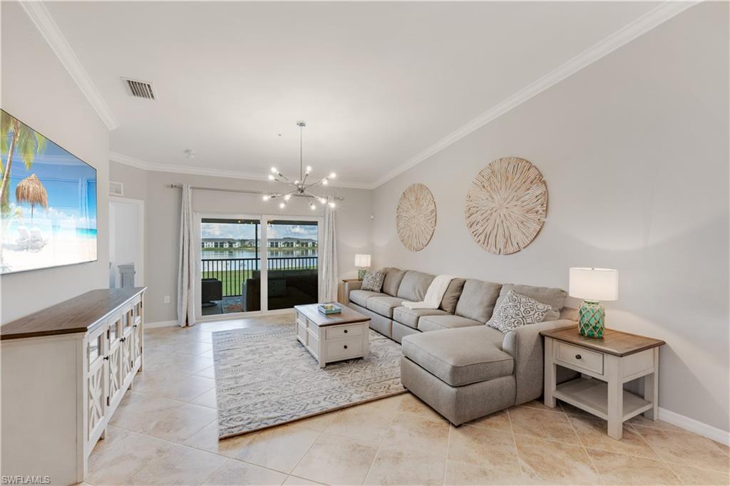 43041 Greenway Boulevard, Unit 921 Babcock Ranch, FL 33982 - Photo 6 of 15 a living room with furniture chandelier and a large window