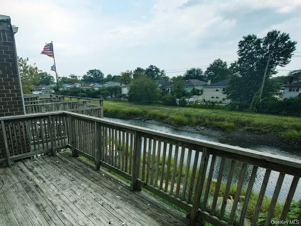 a view of a balcony with wooden fence and floor