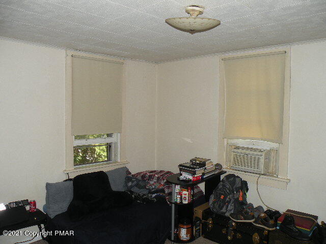 169 Tanite Road Stroudsburg, PA 18360 - Photo 14 of 22 a bedroom with a bed and a chandelier