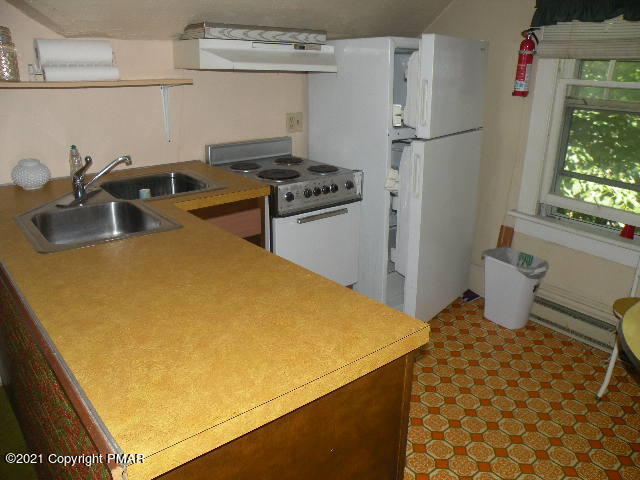 169 Tanite Road Stroudsburg, PA 18360 - Photo 18 of 22 a kitchen with a refrigerator and a sink