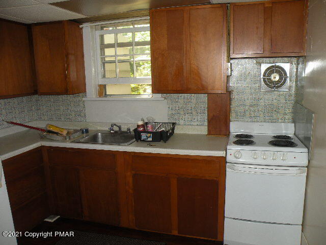 169 Tanite Road Stroudsburg, PA 18360 - Photo 3 of 22 a kitchen with a stove window and cabinets