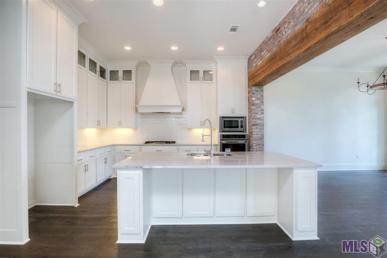 10624 Preservation Way Baton Rouge, LA 70810 - Photo 19 of 23 Kitchen separated from the dining area with old pine beam