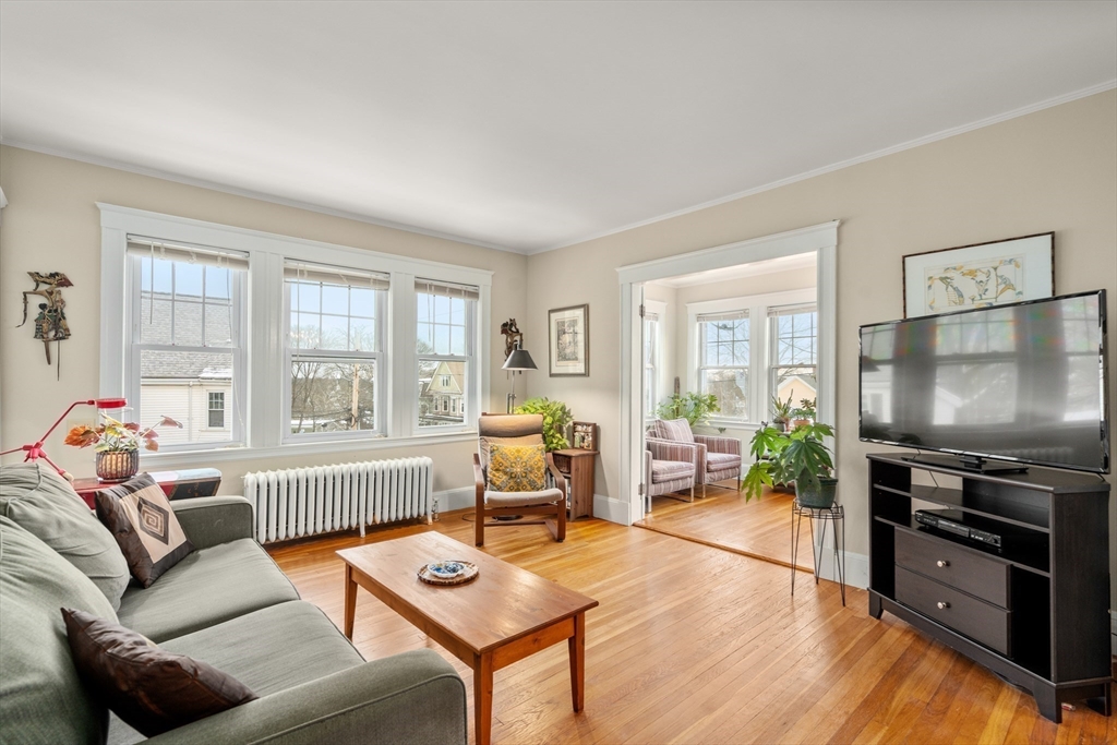 4 Albano Street, Unit 2 Boston, MA 02131 - Photo 3 of 24 a living room with furniture and a flat screen tv with wooden floor