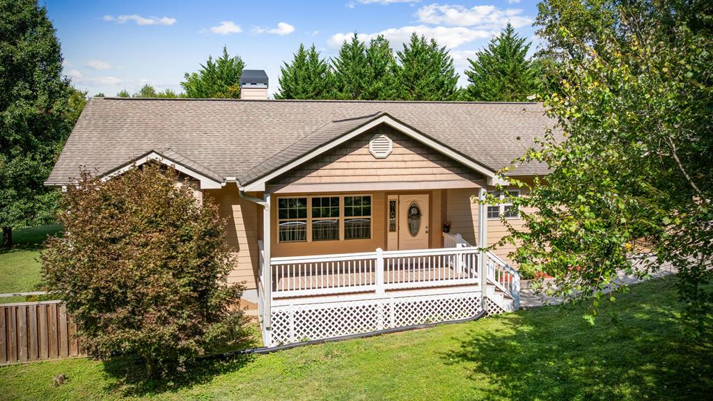 a view of a house with a small yard and wooden fence