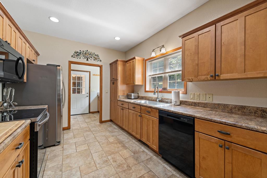 516 Crawford Road Blairsville, GA 30512 - Photo 19 of 49 a kitchen with stainless steel appliances granite countertop a stove sink and cabinets