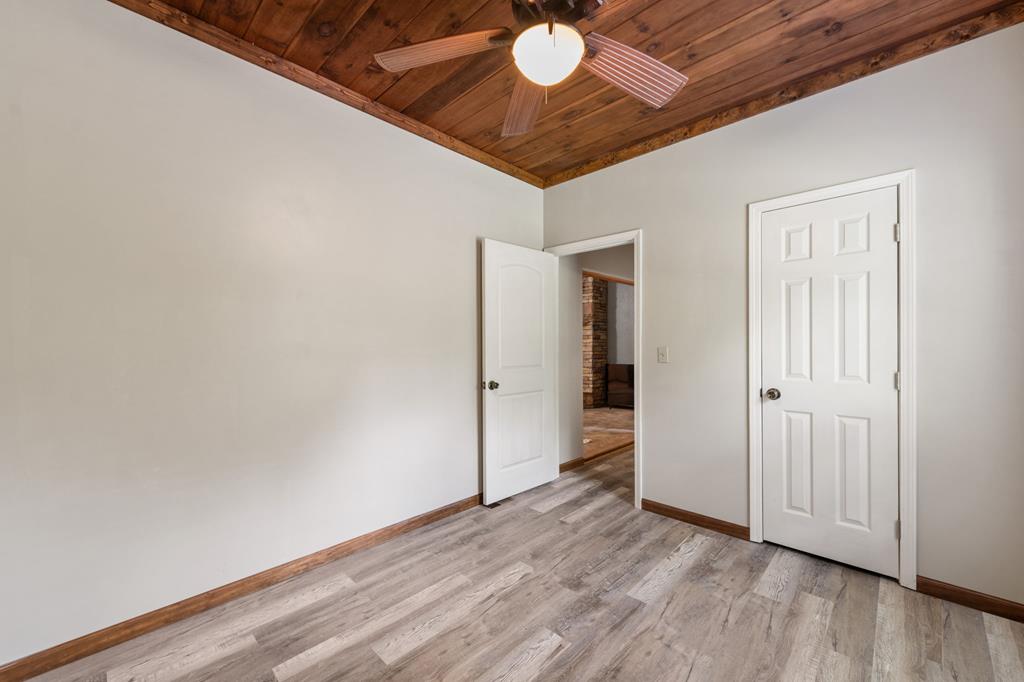 516 Crawford Road Blairsville, GA 30512 - Photo 30 of 49 a view of an empty room with wooden floor and a ceiling fan