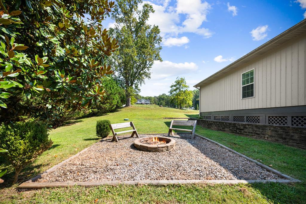 516 Crawford Road Blairsville, GA 30512 - Photo 46 of 49 a view of a backyard with table and chairs and potted plants