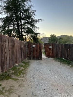 24125 Minton Road Homeland, CA 92548 - Photo 1 of 1 a wooden fence with some trees in the background