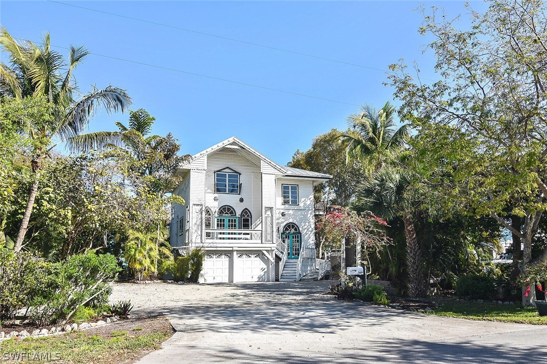 2480 Library Way Sanibel, FL 33957 - Photo 1 of 33 a front view of a house with a yard