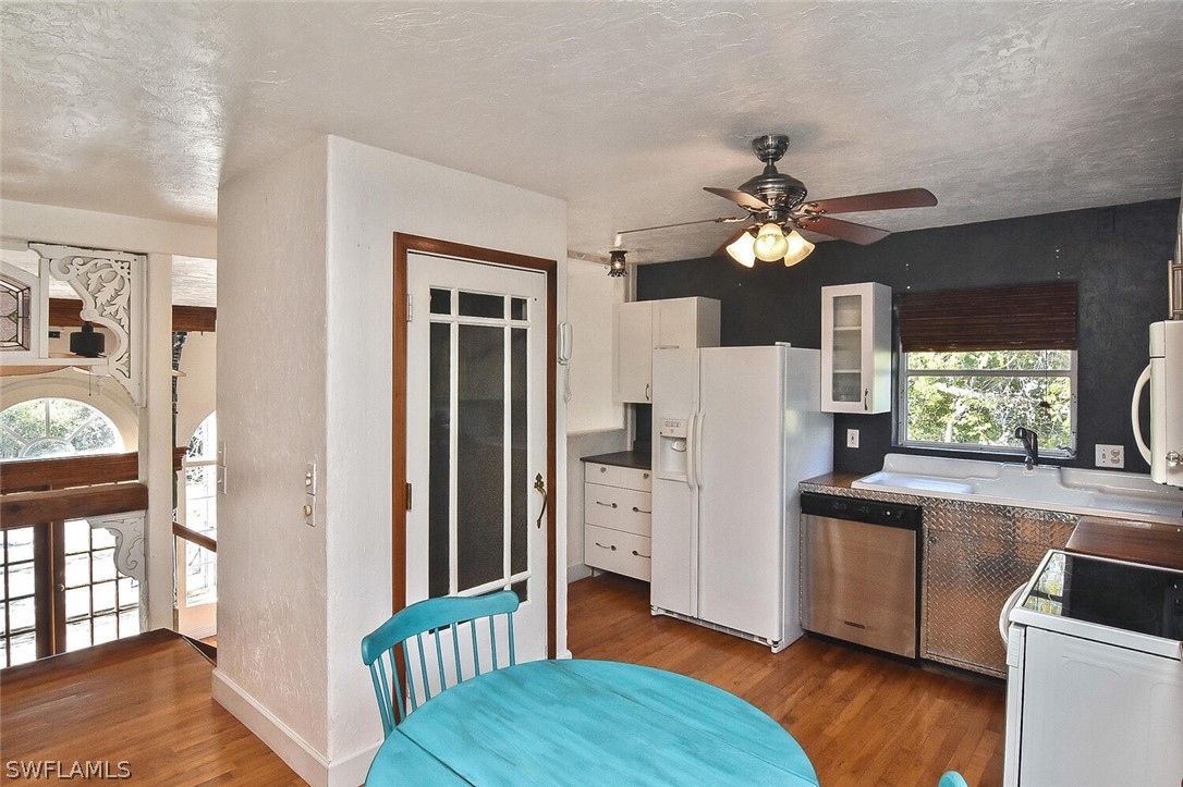 2480 Library Way Sanibel, FL 33957 - Photo 13 of 33 a kitchen with stainless steel appliances a refrigerator and a stove top oven