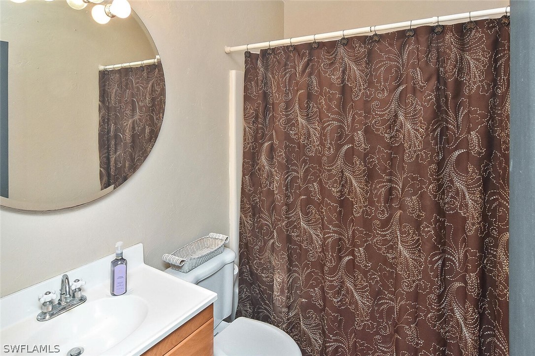 2480 Library Way Sanibel, FL 33957 - Photo 15 of 33 a bathroom with a sink and a mirror