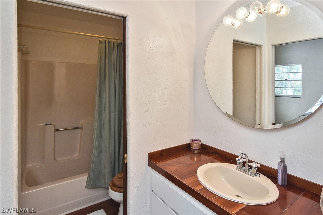 2480 Library Way Sanibel, FL 33957 - Photo 20 of 33 a bathroom with a sink and a mirror