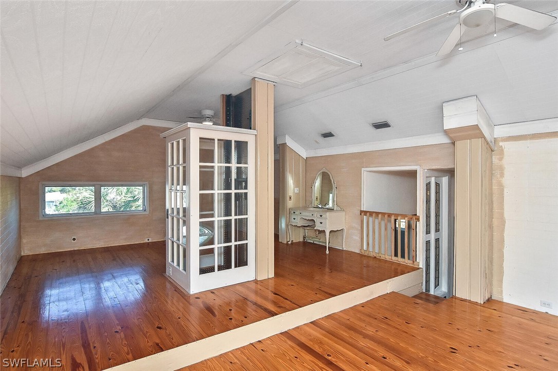 2480 Library Way Sanibel, FL 33957 - Photo 23 of 33 a view of an empty room with wooden floor and a window