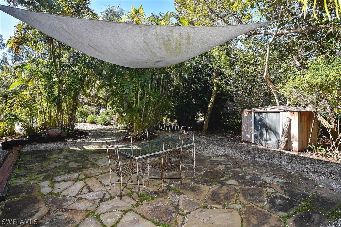2480 Library Way Sanibel, FL 33957 - Photo 29 of 33 a view of a backyard with fountain plants and large tree