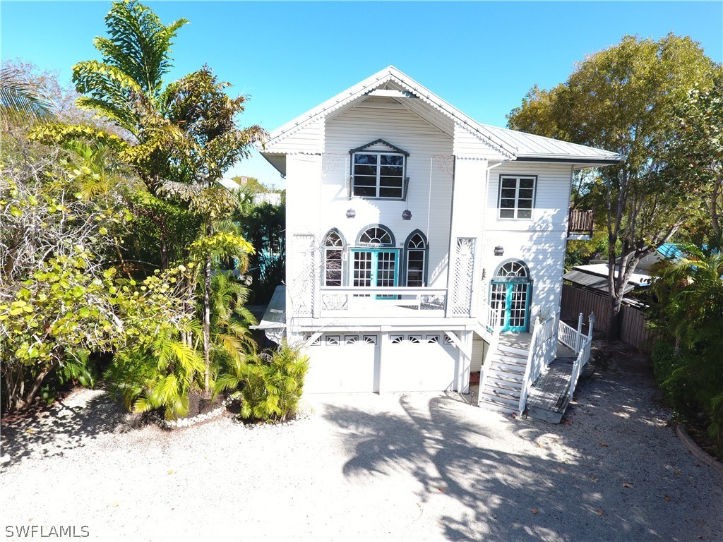 2480 Library Way Sanibel, FL 33957 - Photo 31 of 33 a front view of a house with patio