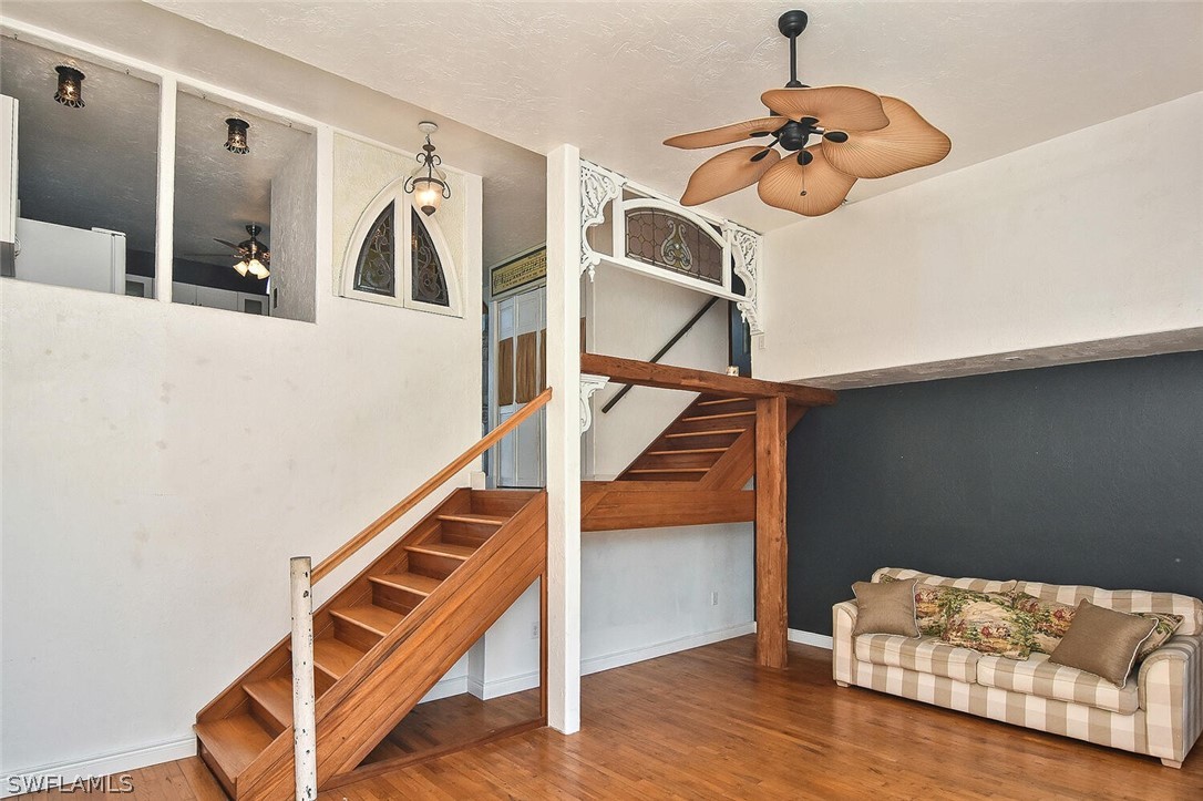 2480 Library Way Sanibel, FL 33957 - Photo 10 of 33 a living room with stairs and a wooden floor