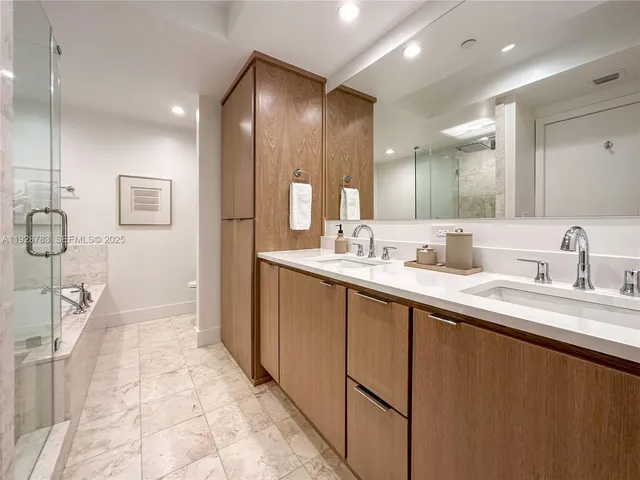 a spacious bathroom with a double vanity sink and a mirror
