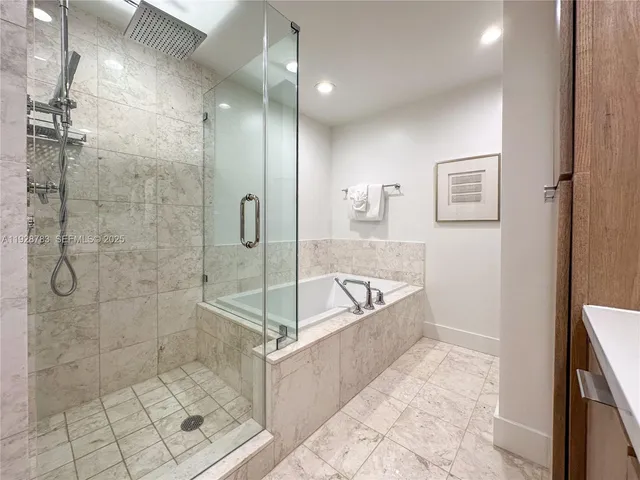 a bath room with a bath tub and shower