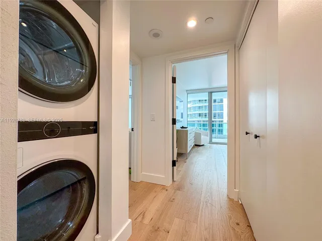 a view of a hallway with washer and dryer