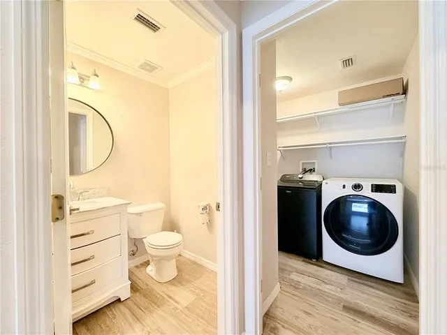 a view of a bedroom with washer and dryer