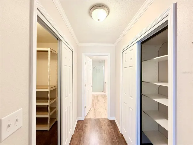 a view of a hallway with wooden floor and entryway