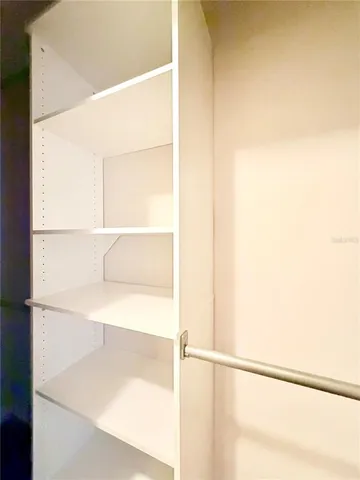 a bathroom with a granite countertop sink a mirror and a shower