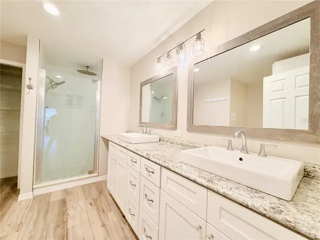 a view of bathroom with a shower and a glass door