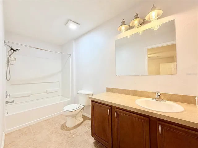 a view of a room with a ceiling fan and a window