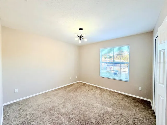 a view of an empty room with a ceiling fan