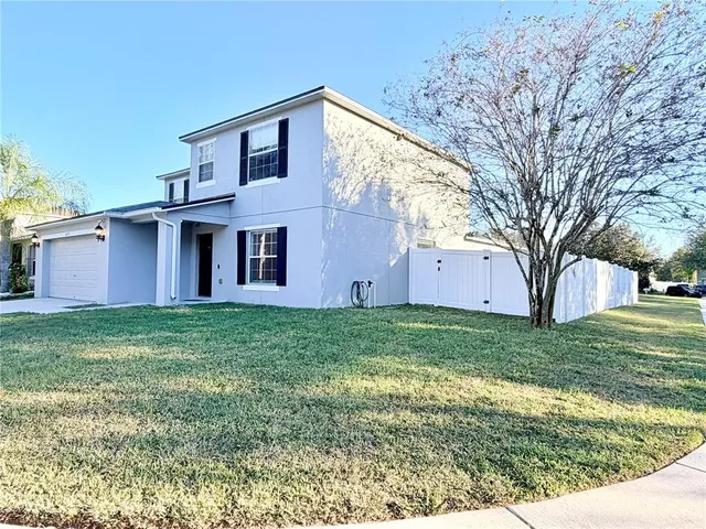 a front view of house with yard and green space