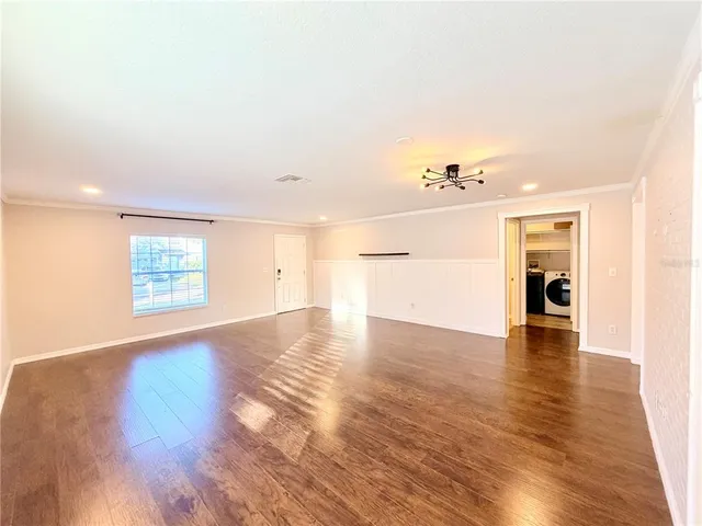 a view of an empty room and wooden floor