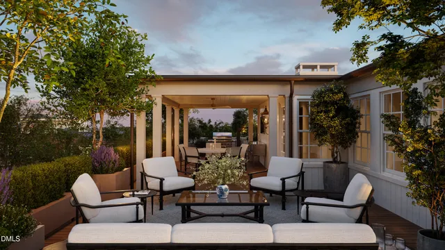 a view of a patio with couches table and chairs and potted plants
