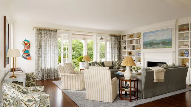 a living room with fireplace furniture and a large window