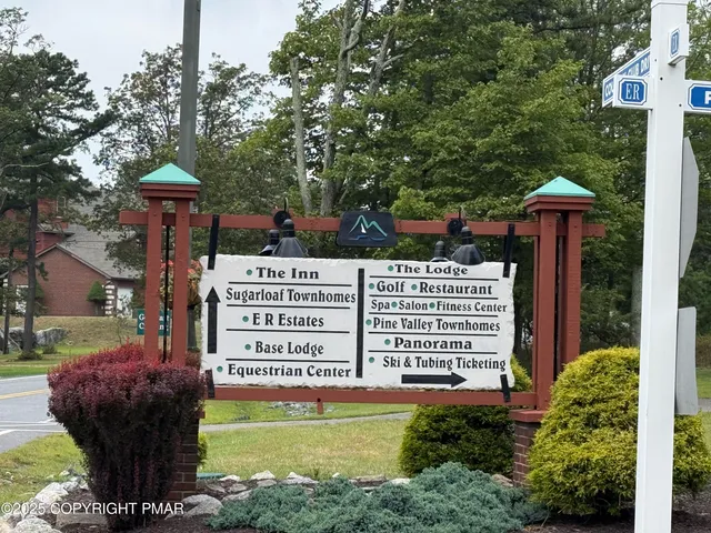 a view of a field with an trees in the background