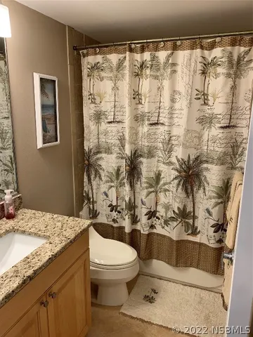 a view of room with cabinet and a flat screen tv