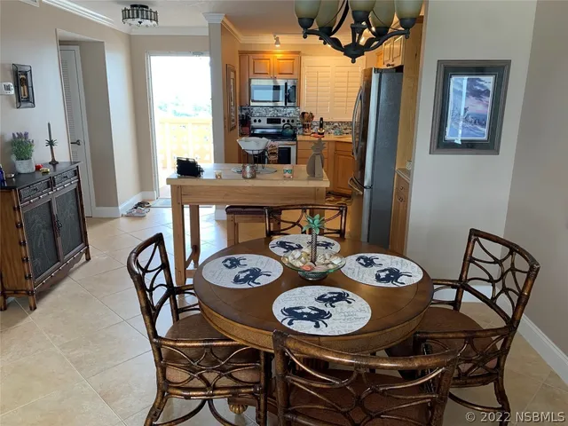 a room with furniture a chandelier and a window