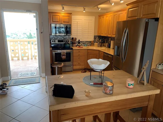 a kitchen with a refrigerator sink and stove