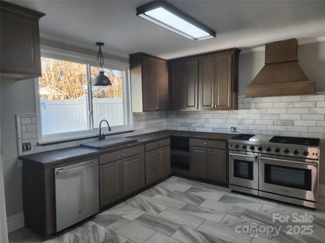 a kitchen with a sink stove and cabinets