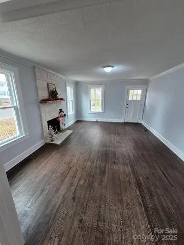an empty room with wooden floor and a window