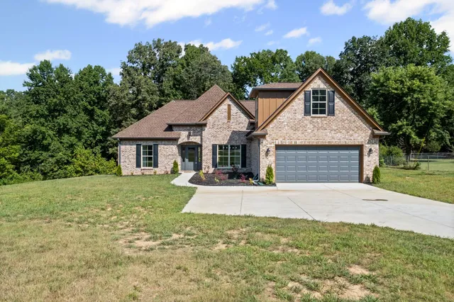 a front view of a house with a yard and garage