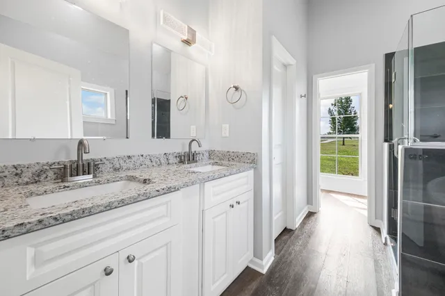 a bathroom with a granite countertop sink toilet and shower