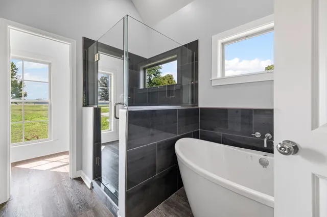 a bathroom with a bathtub and a shower