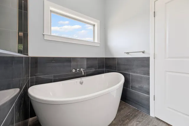 a white bath tub sitting in a bathroom