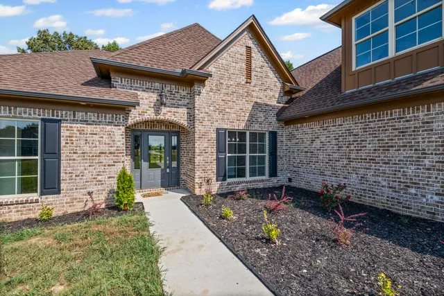 a front view of a house with garden