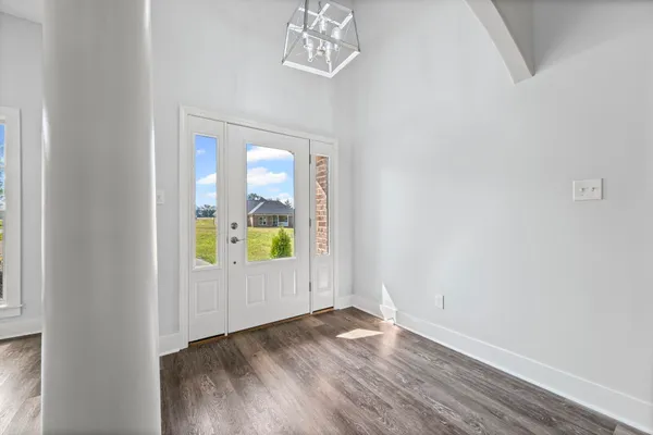 a view of an entryway with wooden floor