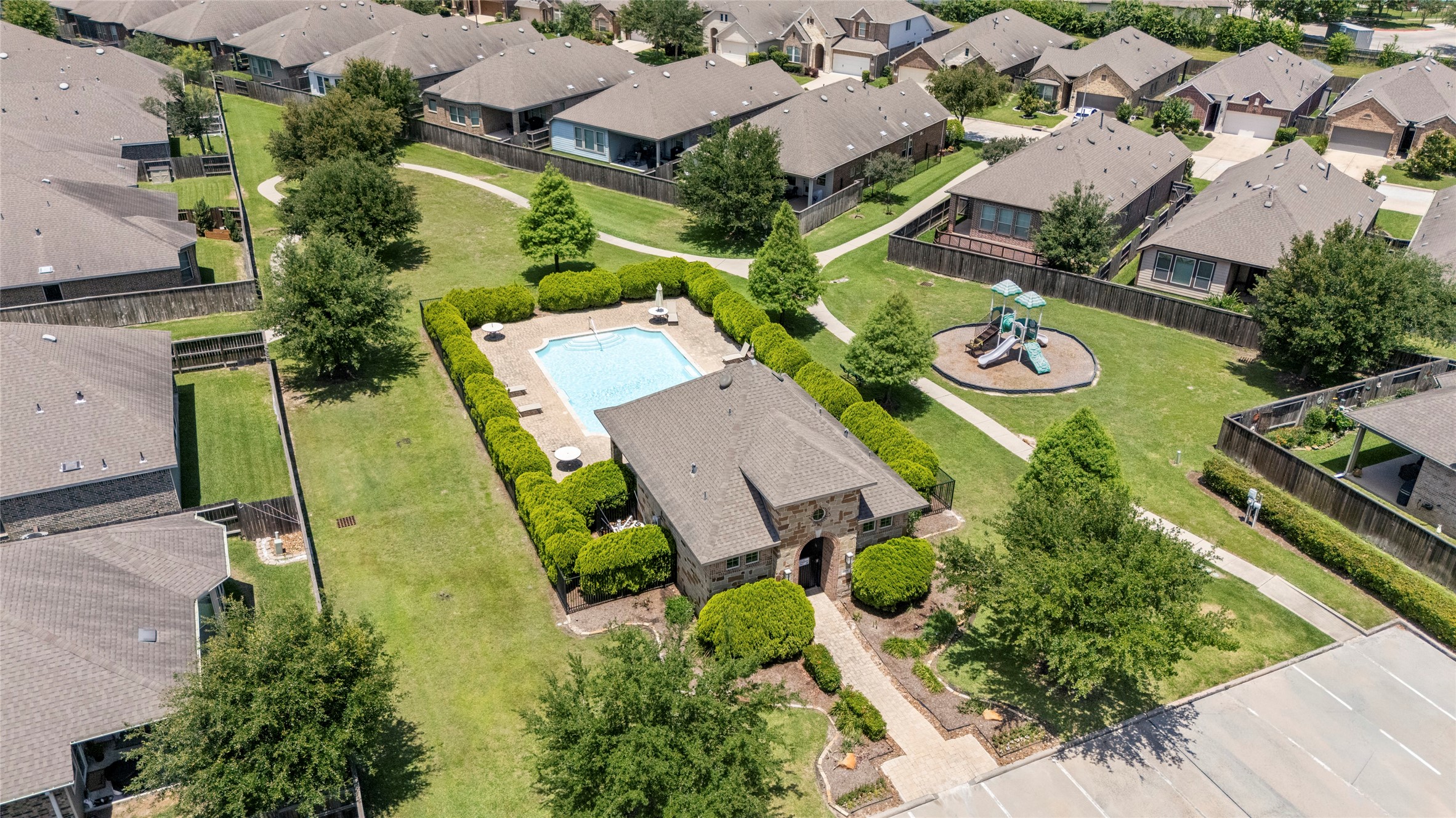 143 Castlegate Lane Houston, TX 77065 - Photo 2 of 33 Enjoy access to a sparkling neighborhood pool with comfortable surroundings for residents and guests.