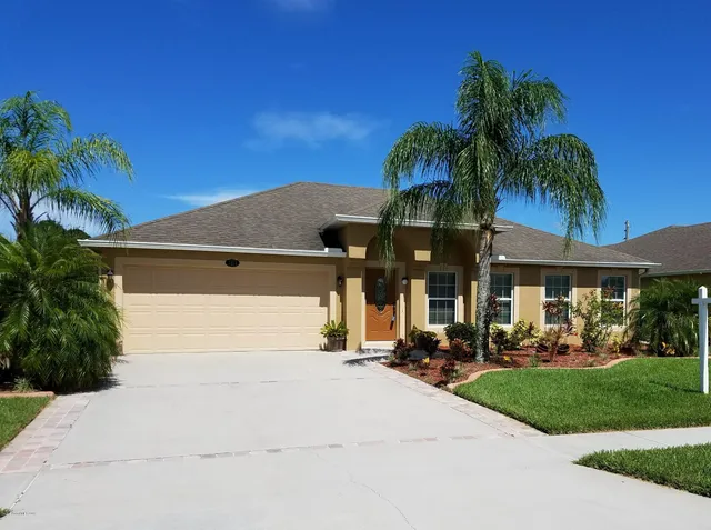a front view of house with yard and green space