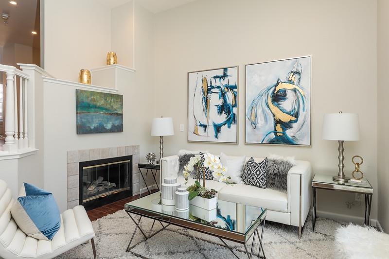 a living room with furniture a couch and a fireplace