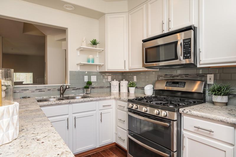 116 Pacchetti Way Mountain View, CA 94040 - Photo 9 of 24 a kitchen with stainless steel appliances granite countertop grey cabinets a stove a sink and a microwave